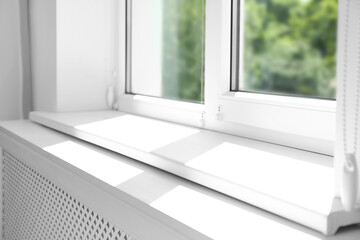 Fototapeta na wymiar Closeup view of window with empty white sill