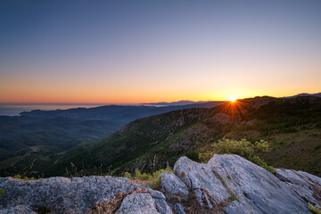 Sun rising over coastline of Corsica