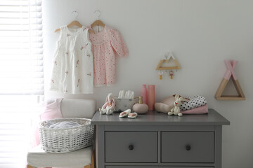 Stylish chest of drawers and accessories in child room