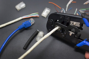 The LAN cable that enters the RJ45 head is crimped with crimping pliers and a LAN cable plugged...