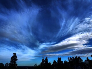 Silhouettes of trees against the backdrop of a dramatic sky - Lilleaker 