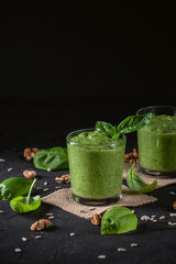 Homemade spinach smoothie on dark background
