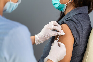 doctor holding syringe and using cotton before make injection to patient in medical mask. Covid-19 or coronavirus vaccine - obrazy, fototapety, plakaty