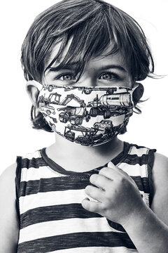 young boy wearing a striped shirt and a mask on a white background in black and white, vertical close up