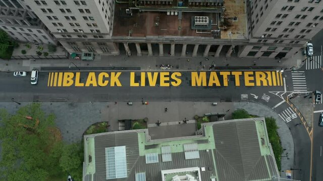 aerial view of BLM sign painted on Joralemon St. in downtown Brooklyn flying bkwd and tilting up
