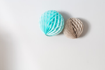 Colorful decoration paper balls garland on a white wall background
