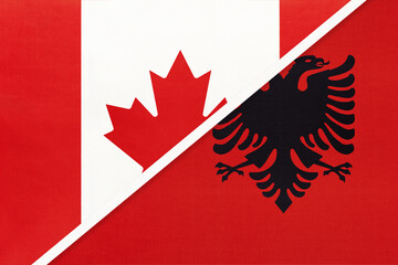 Obraz premium Canada and Albania, symbol of national flags from textile. Championship between two countries.