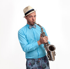 Young man with saxophone over white background.