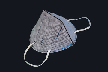 Gray n95 mask. KN95 or N95 mask for protection pm 2.5/pm2.5 and corona virus (COVID-19) on black background with clipping path.