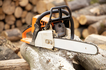 Chainsaw in action cutting wood. Man cutting wood with saw, dust and movements. Chainsaw. Close-up...