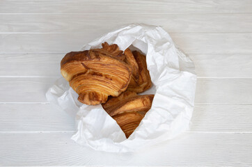 Croissants in a white paper bag