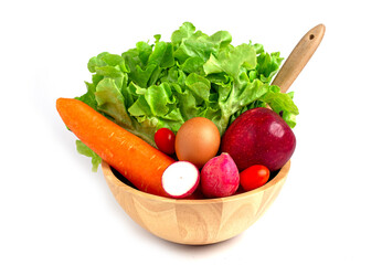 Fresh vegetables and salad ingredients in wooden bowl, green oak, apple, carrot, egg, radish and tomato, Healthy food concept