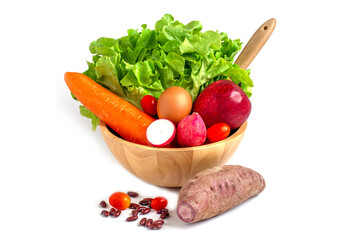 Fresh vegetables and salad ingredients in wooden bowl, green oak, apple, carrot, egg, radish, tomato, red been and purple sweet potato, Healthy food concept