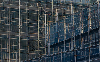 Golden scaffolding fence structure of building exterior wall