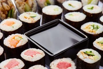 Various kinds of sushi roll set served on cutting board. Japanese food