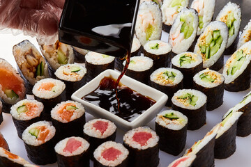 Various kinds of sushi roll set served on cutting board. Japanese food