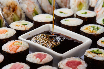 Various kinds of sushi roll set served on cutting board. Japanese food
