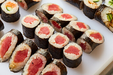 Various kinds of sushi roll set served on cutting board. Japanese food