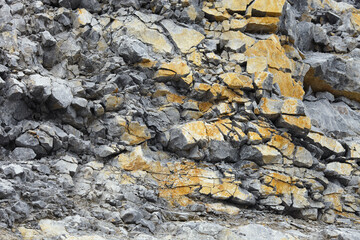 Texture and detail close-up of shattered rocks in the quarry mining enterprise.