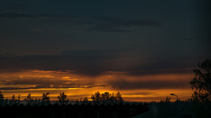 Obraz premium landscape with a colorful sunset over the roof, view through the window