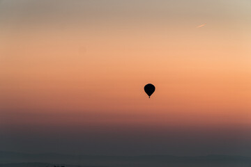 The silhouette of a hot air balloon during sunrise.