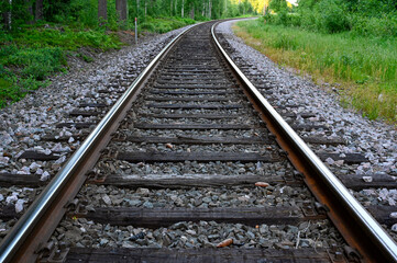 low perspective of rail tracks into a bend