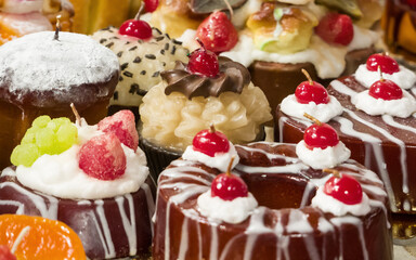 Christmas candles in the shape of muffins with candied fruit and whipped cream