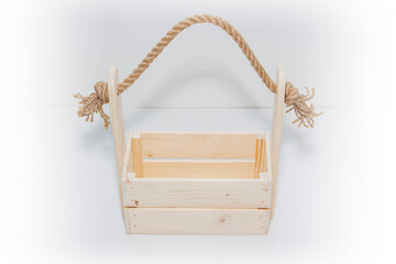 An empty wooden box. Made of pine and plywood, on a light white background.
