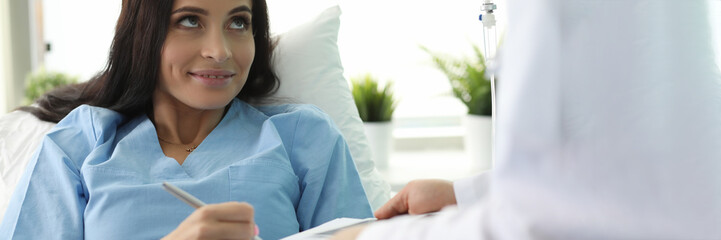 Patient lies on bed in clinic signs document. Unforeseen situation. Diagnostic and treatment procedures. Introduction medicines requires testing for compatibility. Lack allergic reactions