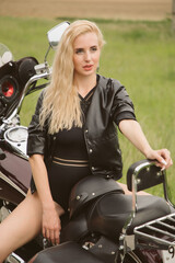 Fototapeta na wymiar Blonde girl on a motorcycle
