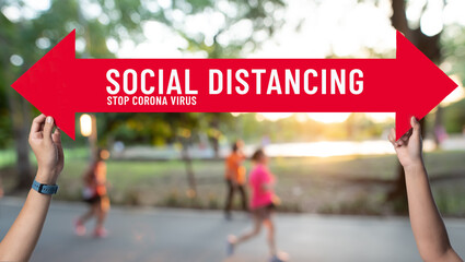 Social distancing,holding sign with message about social distancing ,Space between people to avoid...