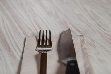 Close up of cutlery on wooden table. Stainless steel fork and knife