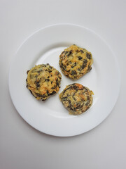 Rolade daun singkong, is a fried food from Indonesia. Made from cassava leaves, tofu and flour. Isolated in white background.
