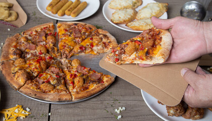 Delivering a slice of barbecue pizza in a cardboard container. Pizza party. Italian meat pizza on wooden background.