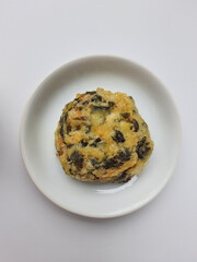 Rolade daun singkong, is a fried food from Indonesia. Made from cassava leaves, tofu and flour. Isolated in white background.