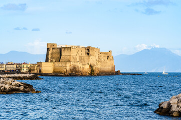 Ovo Castle in Naples, Italy on the peninsula of Megaride in the Gulf of Naples Naples with mount Vesuvius in the background