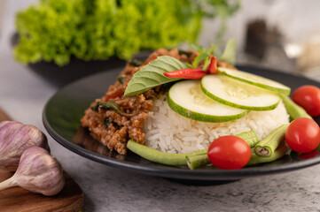 Spicy minced pork and rice on a black plate.