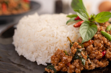Spicy minced pork and rice on a black plate.