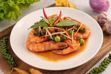 Chuchi shrimp on a plate with fresh pepper seeds