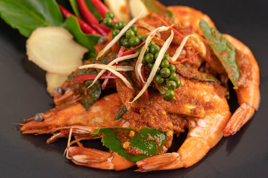 Chuchi shrimp on a plate with fresh pepper seeds