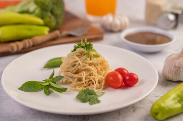 Spaghetti on a plate with tomatoes Coriander and basil.