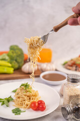 Spaghetti on a plate with tomatoes Coriander and basil.
