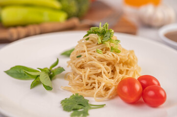 Spaghetti on a plate with tomatoes Coriander and basil.