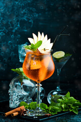 Cocktail in a glass - Aperol spritz. on a black stone background. Menu bar. Alcohol.
