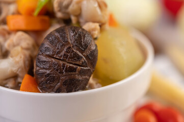Pork ball soup in a cup on a blue-white cloth.