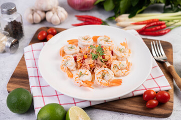 Spicy salad with shrimp on a white plate. Thai food.