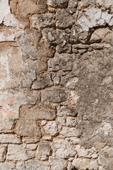 An old wall that is collapsing. Bricks visible. Textured.