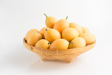 yellow Marian plum in a basket