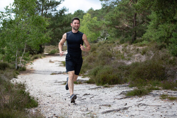 Man jogging on sand in the countryside