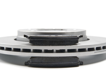brand new brake discs and brake pad set for car. isolated on white with copy space.